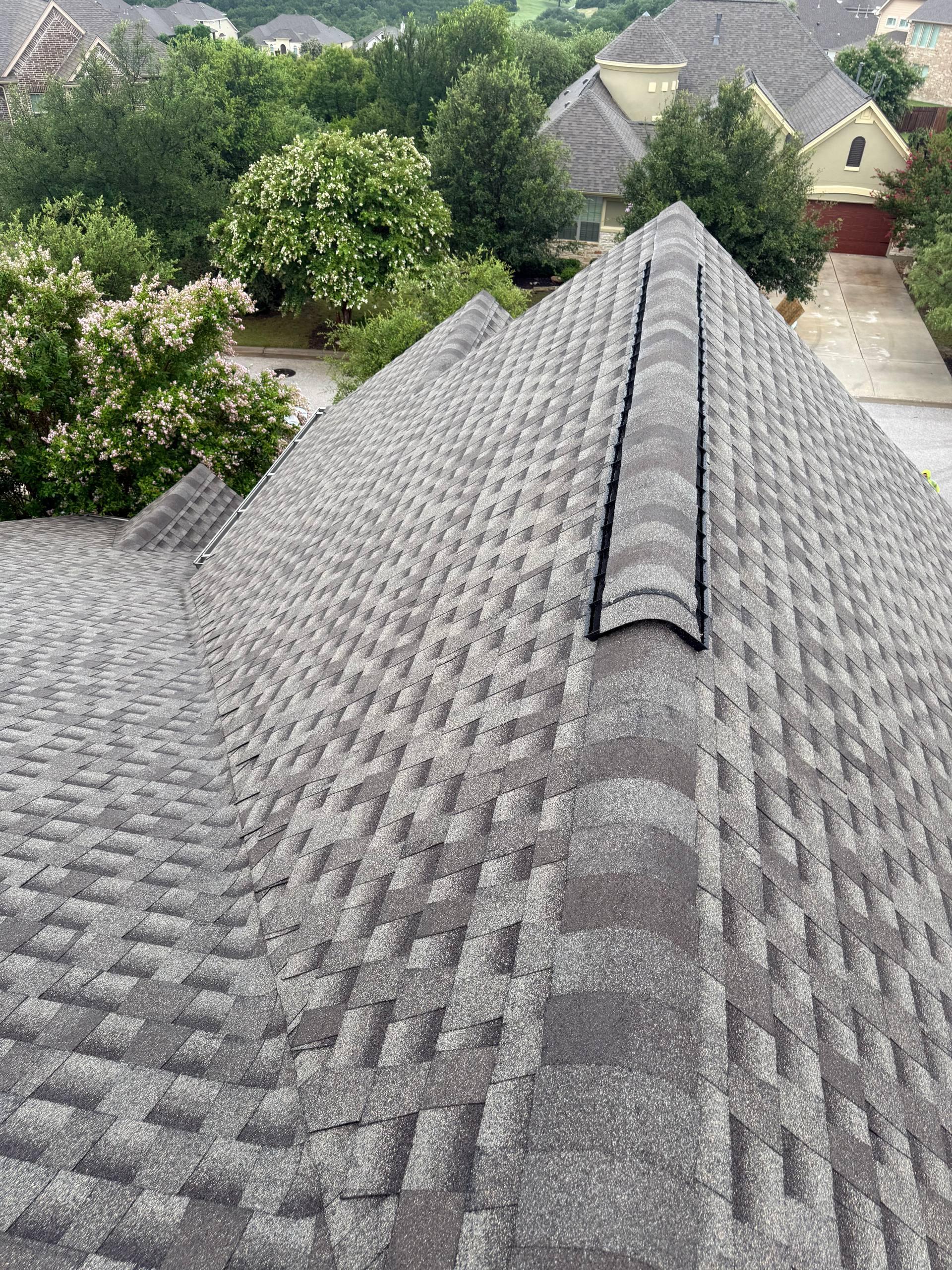 Beautiful finished architectural shingle roof with ridge caps