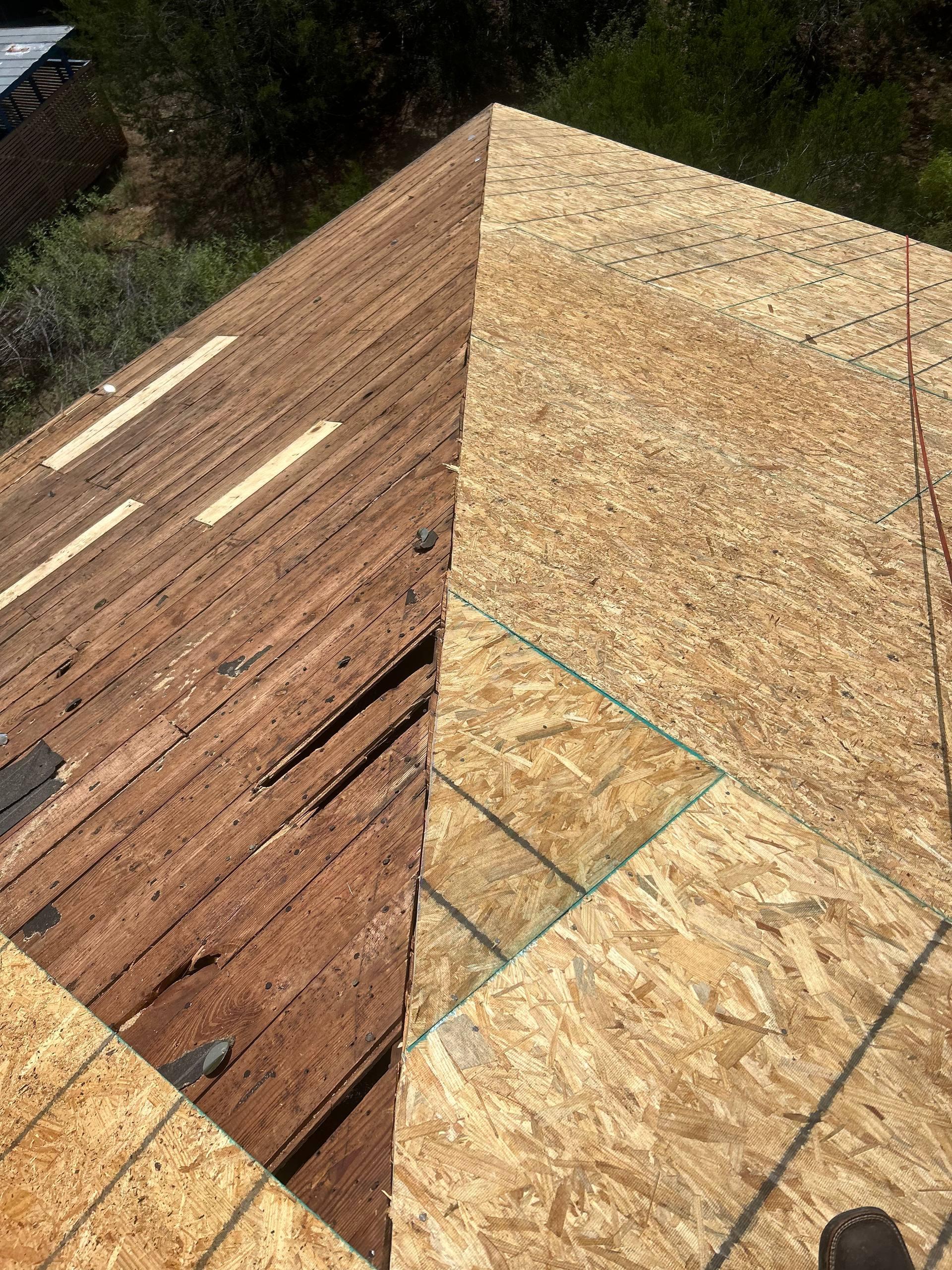 Old rotted wood planks replaced with new OSB decking